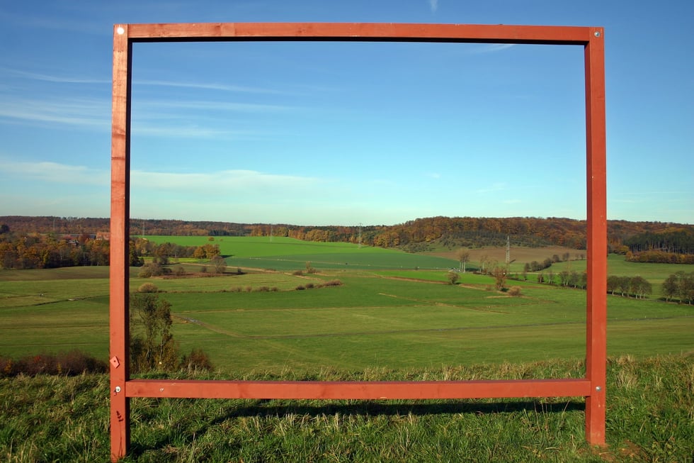 hills and fields through wooden frame