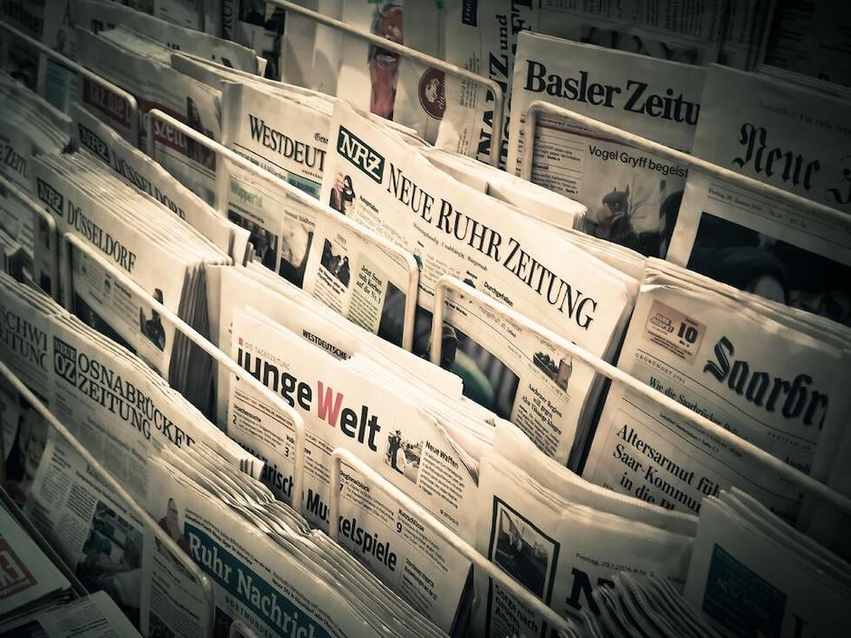 German newspapers in news stand with headlines showing