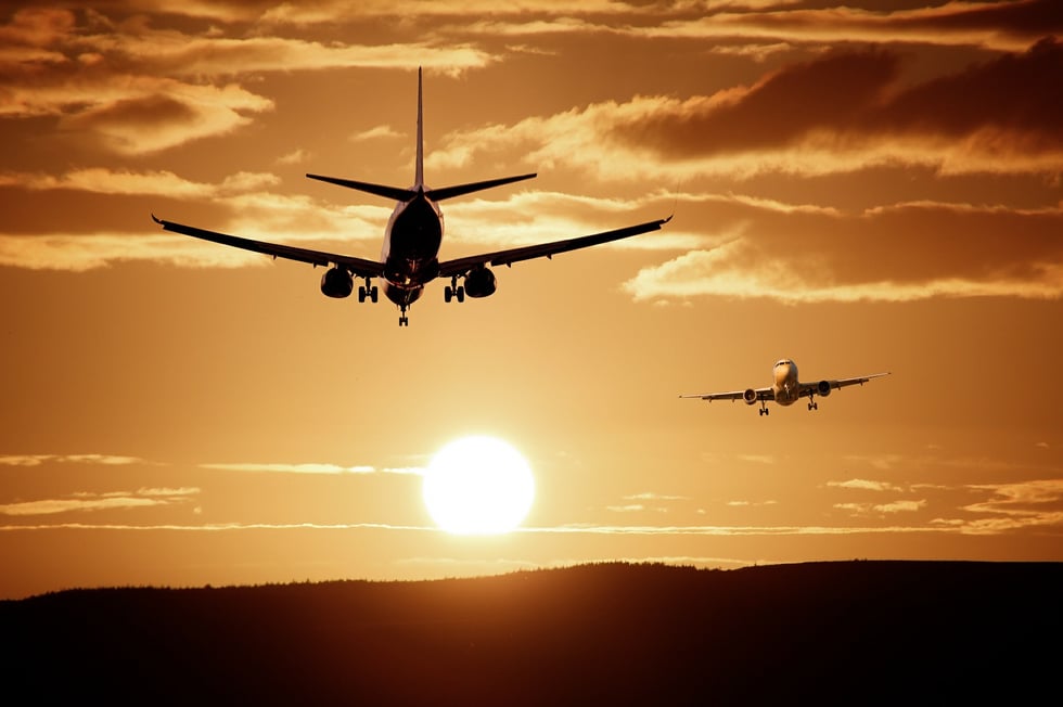 airplanes landing at sunset